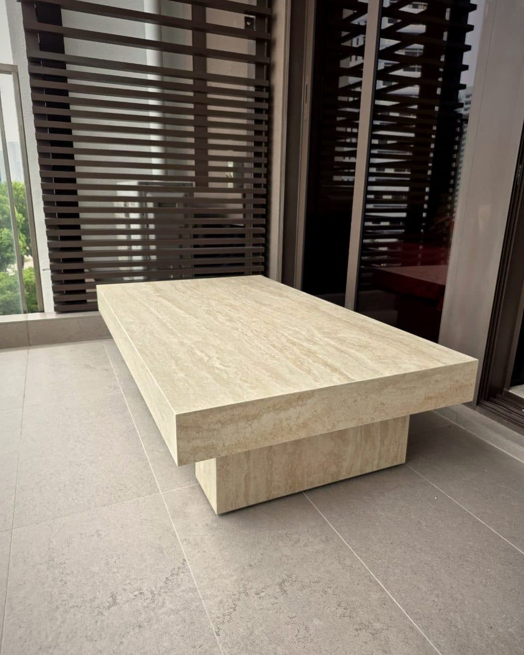 A travertine coffee table on new floor tiles in a BTO flat