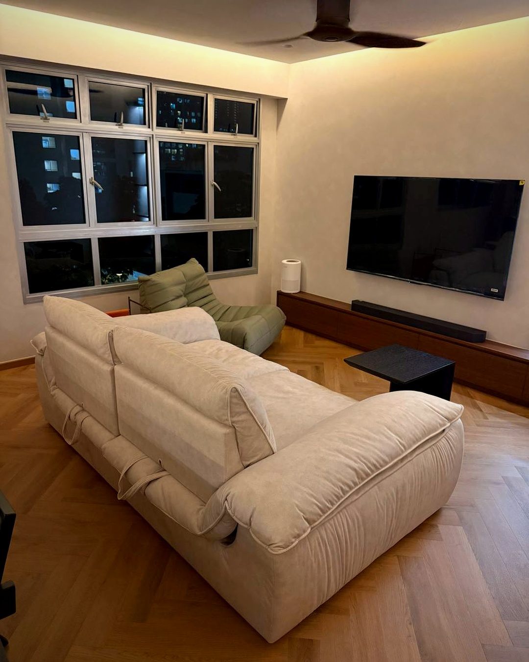 A furnished living room with a large sofa and lounge chair covering most of the floor