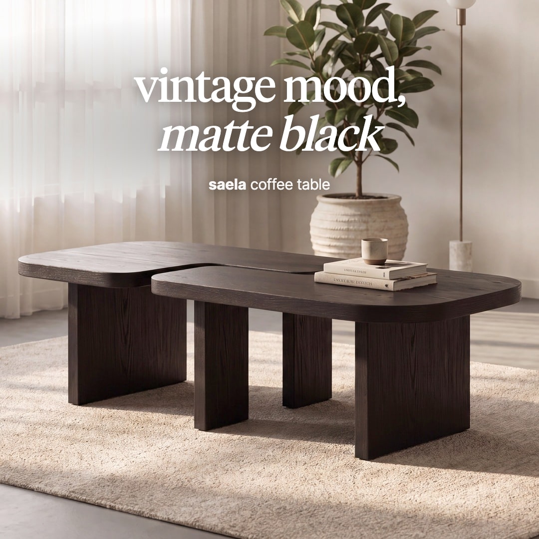 Saela coffee table in matte black, two offset tops on slab legs. The image reads "vintage mood, matte black, saela coffee table".