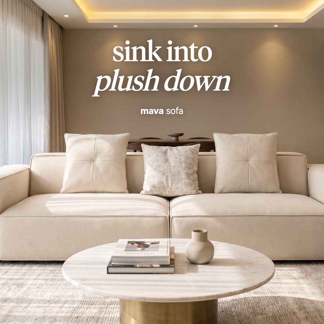Mava sofa in pale cream with square cushions, in a softly lit living room. The image reads "sink into plush down, mava sofa".