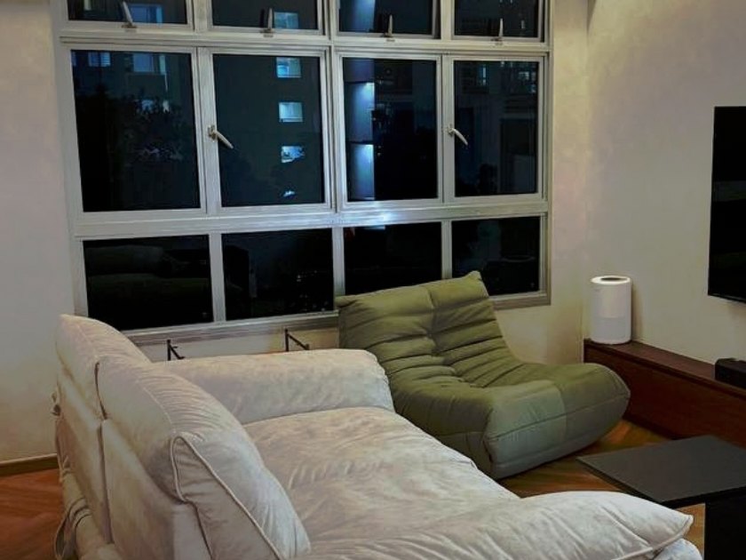 A cream Slova sofa with chaise and a moss-green Rosae lounge chair in a newly furnished 4-room BTO living room
