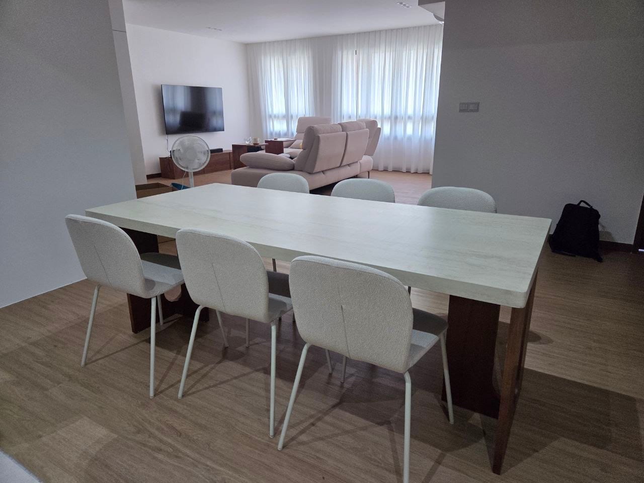 Brian's dining table with six upholstered chairs in a 4-room flat in Tengah